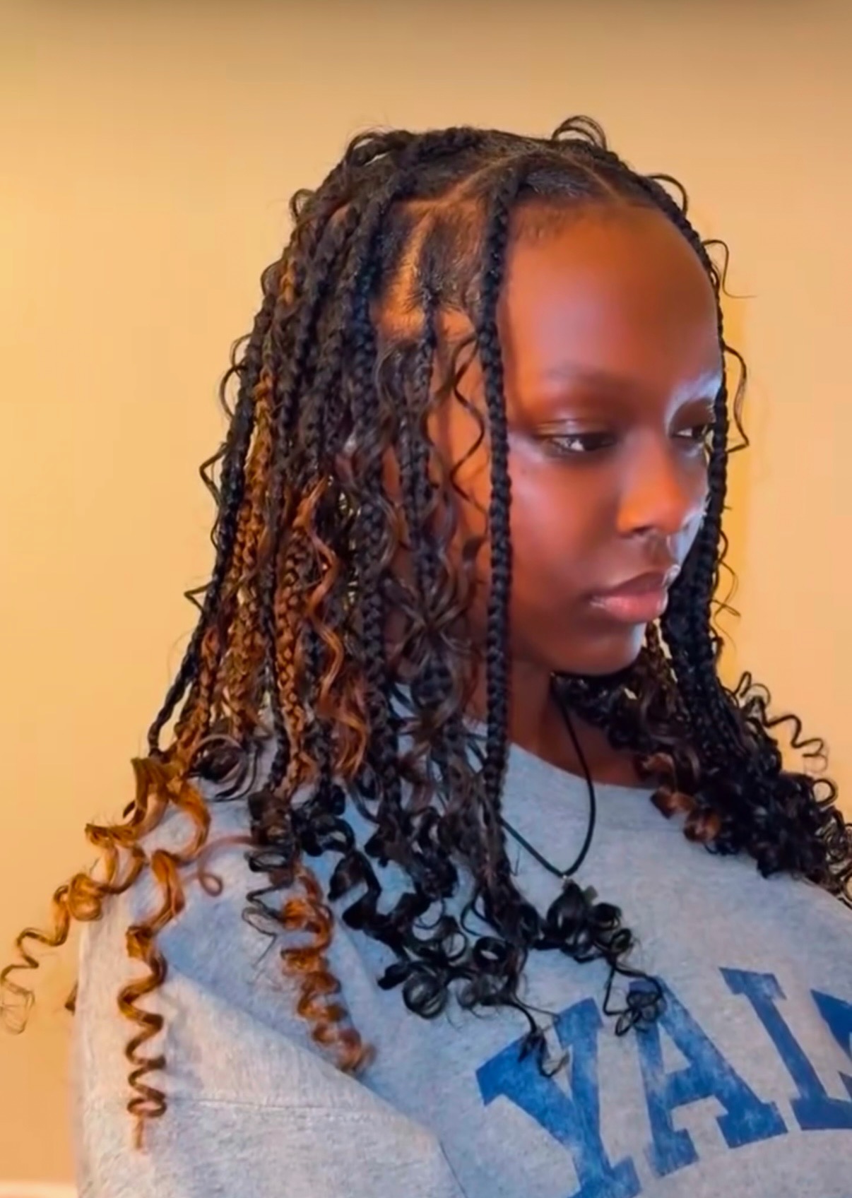 Shoulder-length boho bob knotless braids with curly ends