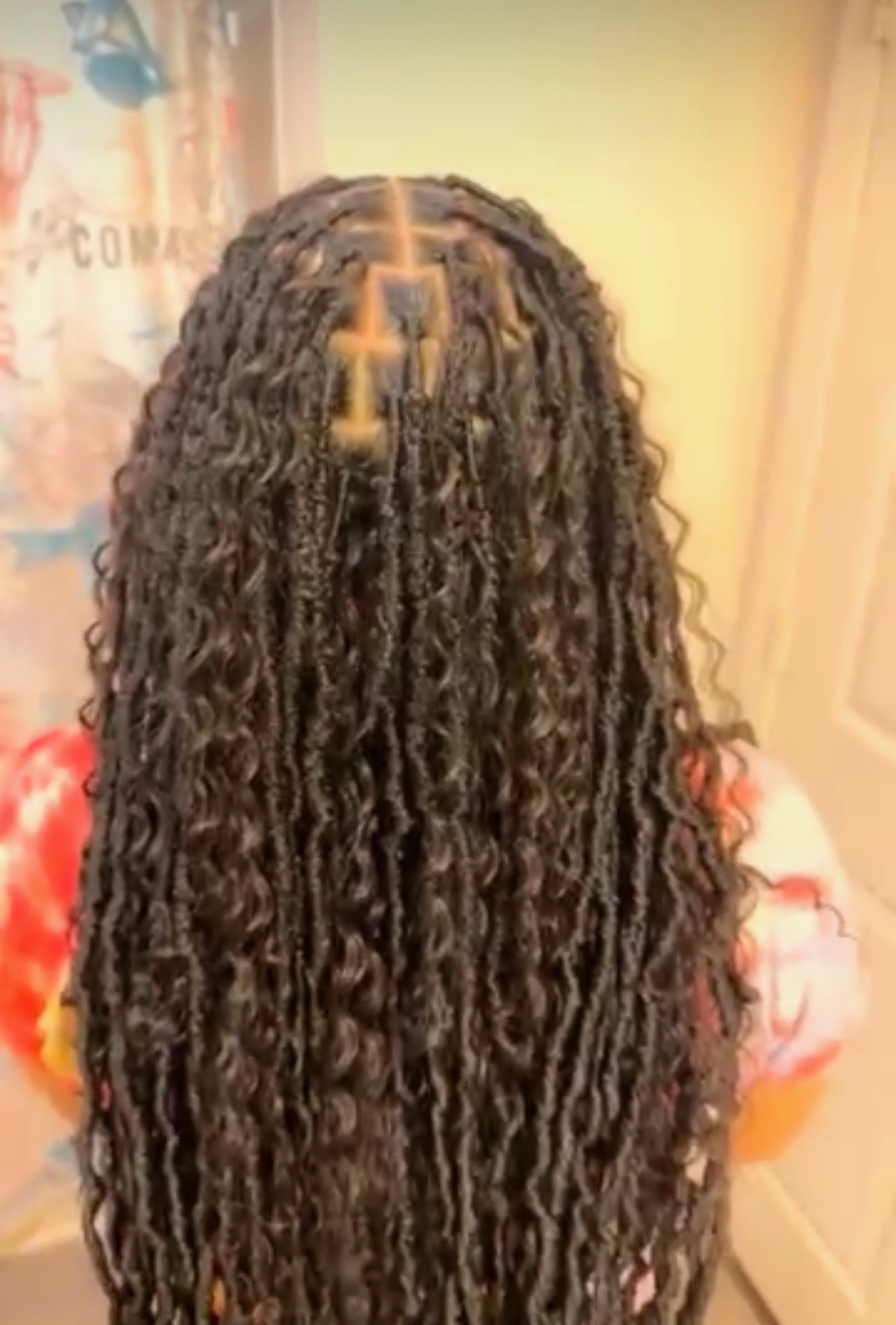 Long boho soft locs with curly ends, back view
