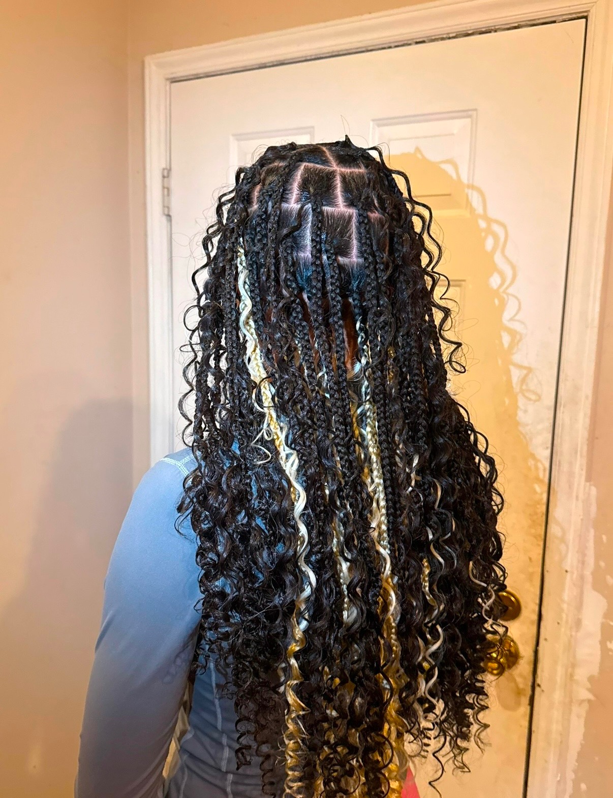 Long smedium boho knotless braids with curls and blonde accents, back view
